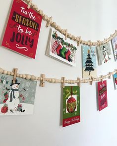 christmas cards are hung on a clothes line