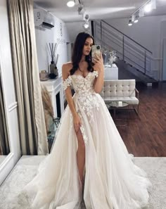 a woman is taking a selfie in her wedding dress while standing on the floor