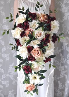 a bride holding a bouquet of flowers in her hands