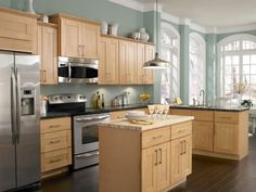 a kitchen with wooden cabinets and stainless steel appliances