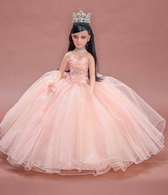 the doll is wearing a pink dress with a tiara on it's head