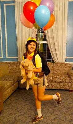 a woman holding a teddy bear in her arms with balloons around her head and the caption reads, 13 russell from up