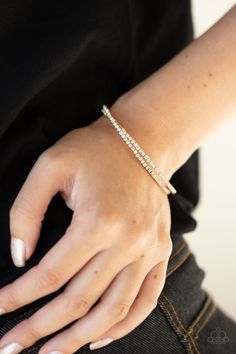 Featuring glistening gold fittings, two rows of glassy white rhinestones delicately twist into a dainty cuff around the wrist.

 Sold as one individual bracelet. Thick Silver Ring, Trendy Fringe, Antique Brass Frame, Silver Strand, Hammered Silver Ring, Purple Pearl, Ball Necklace, Teardrop Beads, Paparazzi Accessories