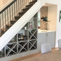 a wine rack under a stair case in a living room