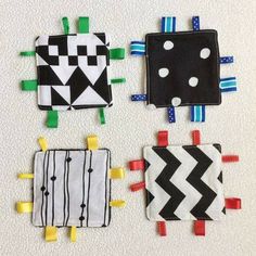 four small pieces of cloth with different designs on them, all in black and white