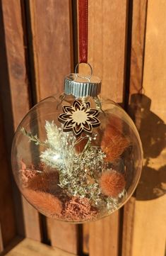 a glass ornament filled with plants and dirt