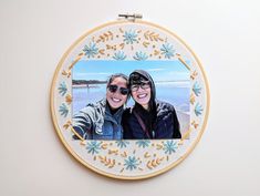 two people are taking a selfie in an embroidered frame