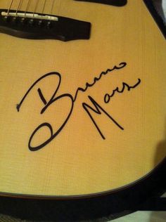 a guitar with a signed name on it