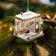 a christmas tree ornament with a small house on it's front porch