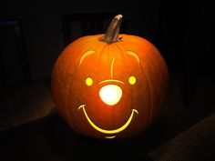 a pumpkin that has been carved to look like a face with glowing eyes and nose