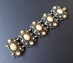 Vintage Faux Pearl Victorian Revival Chunky Wide Bracelet 1940's 1950's Jewelry Measurements Length - 7 3/4 inches Width - 2 inches In very good vintage condition. A nice addition to any collection. D501 Jewelry Measurements, 1950s Jewelry, Desert Hot Springs, Victorian Revival, Wide Bracelet, Hot Springs, Faux Pearl, Beautiful Jewelry, Cuff Bracelets