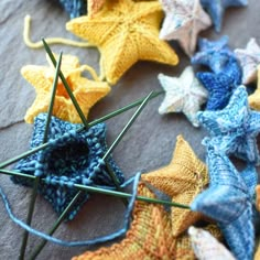 crocheted stars and needles on the ground