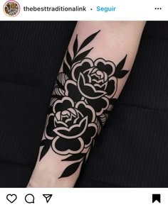 a black and white flower tattoo on the arm