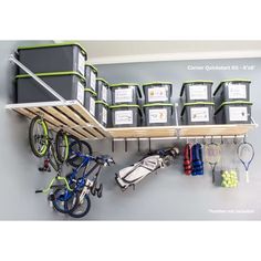 there is a bike and tennis rack in the room with several bins on it