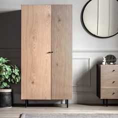 a wooden cabinet sitting next to a mirror on top of a dresser in a room