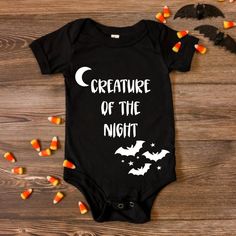 Creature of the night baby bodysuit! A little late night humor for those new parents, and a sweet little treat for any baby shower, Halloween lover, expecting parent to be, or a just because gift! *Bats and candy corn not included* *Other colors for font available, please message me* Mom Goth, Night Humor, Baby Shower Halloween, Creature Of The Night, Halloween Onesie, 2024 Wishlist, Expecting Parents, Parents Baby