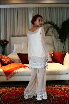 Sarafina Prima is our higher end line and the Ella three piece silk pajama set is from our latest collection. Silks, satin's and exclusive laces tailored for the clientele who is used to the best and perfectly suited for the elegant bride. The Ella pajama is an ultra soft Champagne silk chiffon that drenches the body in luxury. Full tunic top with tapered sleeves, wide neckline and our new Versailles French lace trim around the hem. The pant is our signature full leg, narrow elastic band waist a Elegant Lace Set For Wedding Night, Elegant Fitted Silk Chiffon Sets, Fitted Sheer Set For Wedding, Elegant Sheer Wedding Set, Elegant White Sheer Sleepwear, Sheer Organza Sets For Wedding, Sheer Organza Wedding Sets, Wedding Sheer Organza Sets, White Chiffon Wedding Sets