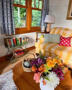 a living room filled with furniture and flowers