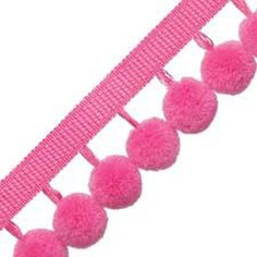 pink pom - poms are hanging from the side of a ribbon