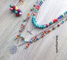 "Live Love Laugh, Boho Style Me Colorful Boho Beaded Layer Necklace, BohoStyleMe, Handmade Bohemian Pendant Necklace This boho colorful beaded necklace is full of happy, fun, mixed colors. A completely hand knotted strand runs along the silver chain, with playful dangles. The focal pendant is two-sided, front reads \"Live, Love, Laugh\", and the backside has a crystal studded etched flower. A delicate dragonfly charm is placed between the strands of beads, the top strand consisting of genuine turquoise and additional bright color glass beads. Silver is used throughout this whimsical boho necklace - enjoy! Length - 31 inches (longest), 25 inches (shortest) Please see all pictures for accurate colors. Created for you - my unique handcrafted jewelry is created individually in my personal desi Colorful Bohemian Beaded Chain Jewelry, Colorful Bohemian Multi-strand Beaded Necklaces, Bohemian Rainbow Beaded Necklaces For Jewelry Making, Bohemian Rainbow Beaded Necklaces For Festivals, Bohemian Multicolor Beaded Necklaces With Spacer Beads, Multicolor Bohemian Beaded Necklace With Spacer Beads, Bohemian Rainbow Jewelry For Festivals, Rainbow Bohemian Jewelry For Festivals, Bohemian Multicolor Jewelry With Spacer Beads