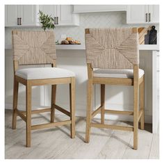 two wooden stools sitting next to each other in a kitchen