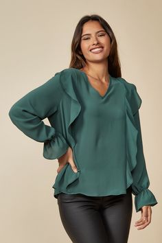 Embrace the casual chic vibe! This elegant and versatile loose-fit v-neck blouse with ruffles and long sleeves is perfect for your summer and spring capsule wardrobe. With its oversized fit and ruffle front details, it combines comfort and style effortlessly. Whether you're relaxing at home or attending a party, this chic blouse is designed to keep you cozy and fashionable. Made from lightweight woven fabric, it's ideal for those warm days. This oversized top fits true to size and is perfect for Blouse With Ruffles, Tops For Summer, Loose Fit Blouse, Spring Capsule Wardrobe, Spring Capsule, Green Fits, Chic Blouses, Stylish Blouse, Elegant Blouses