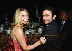 a man and woman sitting next to each other at a table