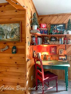 a desk and chair in a room with wood paneling