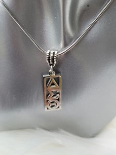 a silver purse with a pendant on it