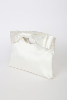 Complete your big day look with the Lulus Total Romantic White Satin Bow Clutch! Sleek woven satin shapes darling clutch that has a cutout handle at the top and a decorative bow at the front. Magnetic closure opens to a lined interior with a single sidewall pocket. Detachable silver chain strap. Fully lined. Bag measures 10. 5" wide, 7. 5" tall, and 1. 75" deep (relaxed). Detachable 46" strap. Strap has a drop of 22â€. Shell: 100% Polyester. Lining: 100% Polyester. Imported. Lulus | Total Roman Bow Clutch, Decorative Bows, Large Bow, Satin Bow, White Satin, Magnetic Closure, Chain Strap, Big Day, Silver Chain