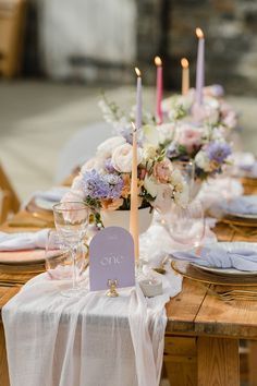 the table is set with flowers and candles