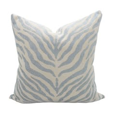 a blue and white zebra print pillow on a white background