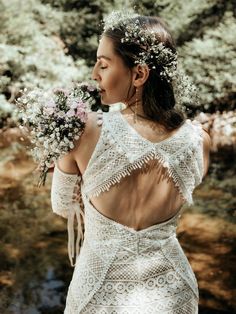 a woman in a white dress holding flowers