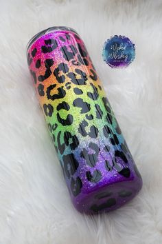 the colorful leopard print tumbler is next to a white fur