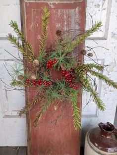 an old door with a wreath hanging on it