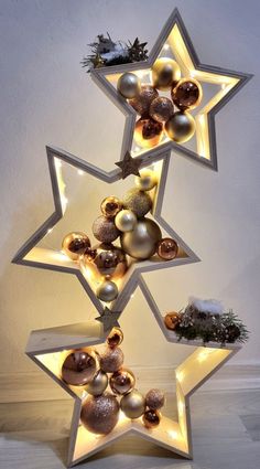 a star shaped christmas tree with ornaments on it's sides and lights in the shape of stars