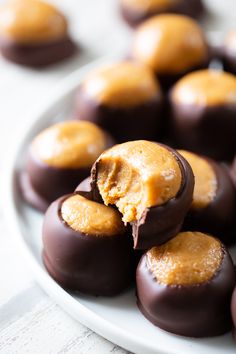 chocolate covered peanut butter balls on a white plate