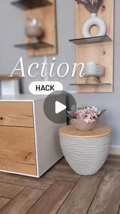 a room with a wooden floor and some shelves on the wall next to a potted plant