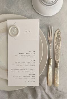 a place setting with silverware and napkins