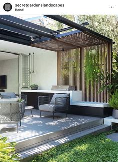 an outdoor living area with furniture and plants on the deck, surrounded by greenery