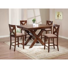 a wooden table with four chairs around it