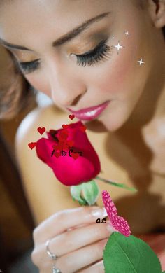 a woman is holding a rose with hearts on it