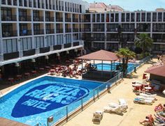 an aerial view of the pool and surrounding buildings