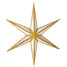 a gold and white star ornament hanging from a string