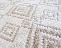 closeup of an area rug with diamond shapes on it