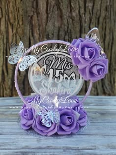 purple roses and butterflies are on top of a clear acrylic plaque that says my child is born