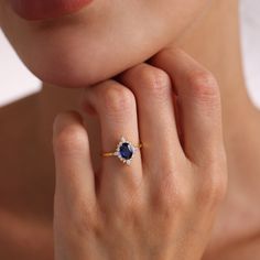 a woman's hand with a diamond and sapphire ring