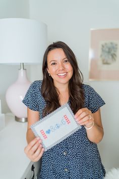 a woman holding up a sign in her hand with the word love spelled on it