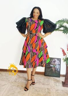 An elegant African two sisters dress to rock that special occasion. Printed Short Sleeve Party Dress, Short Sleeve Printed Party Dress, Short Sleeve Printed Maxi Dress For Parties, Multicolor A-line Maxi Dress For Cocktail, Sleeveless Midi Dress With Vibrant Print For Party, Elegant Multicolor Short Sleeve Dress, Multicolor A-line Midi Dress For Cocktail, Sleeveless Dresses With Vibrant Print For Evening, Sleeveless Dress With Vibrant Print For Evening