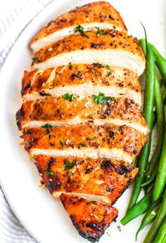 grilled chicken and green beans on a white plate